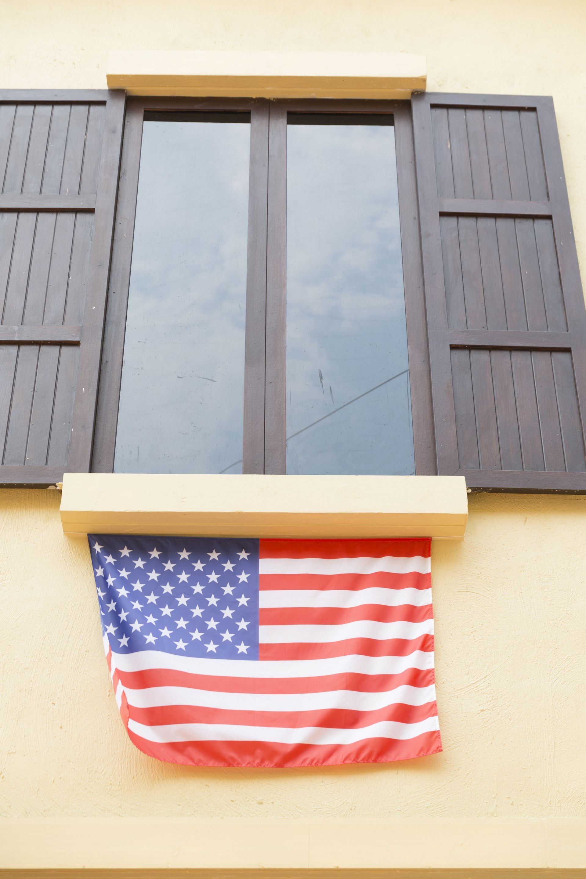 brown wooden window and tinted glass decorating with united states national flag brown wooden window and tinted glass decorating with united states national flag